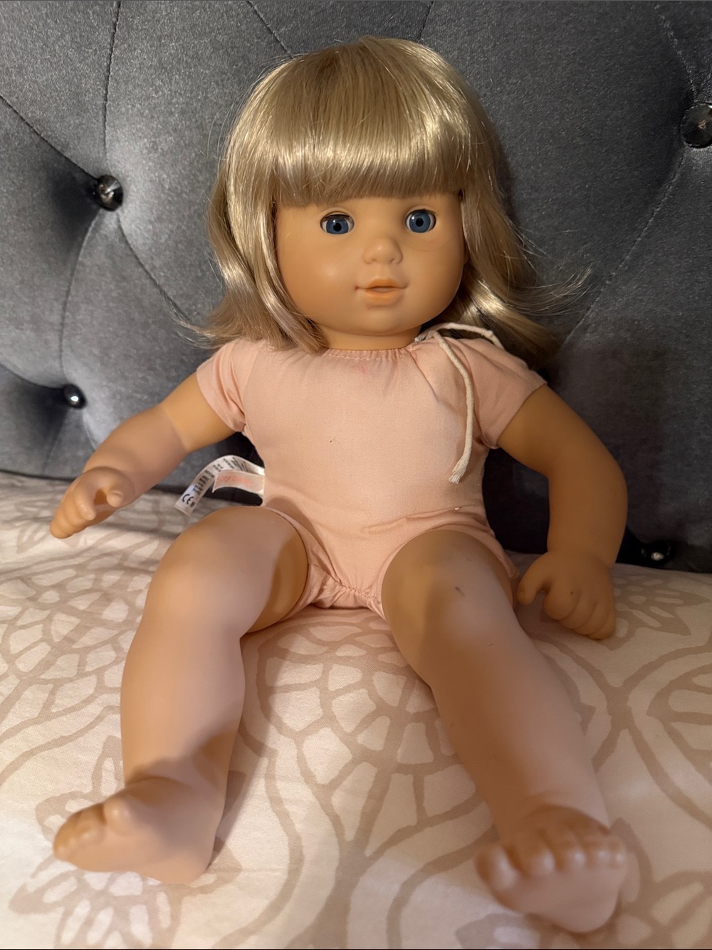 American Girl Blonde-Haired Doll in Pale Pink Romper